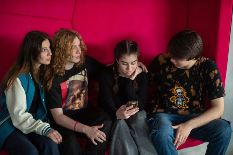 Young adults check social media in North Macedonia.