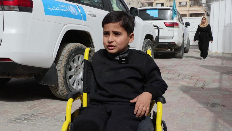 A child arrives at Al-Amal Hospital in his wheelchair in an attempt to get treatment.