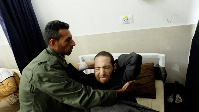 A man takes care of his brother, a cancer patient at Al-Shifa hospital in Gaza City.